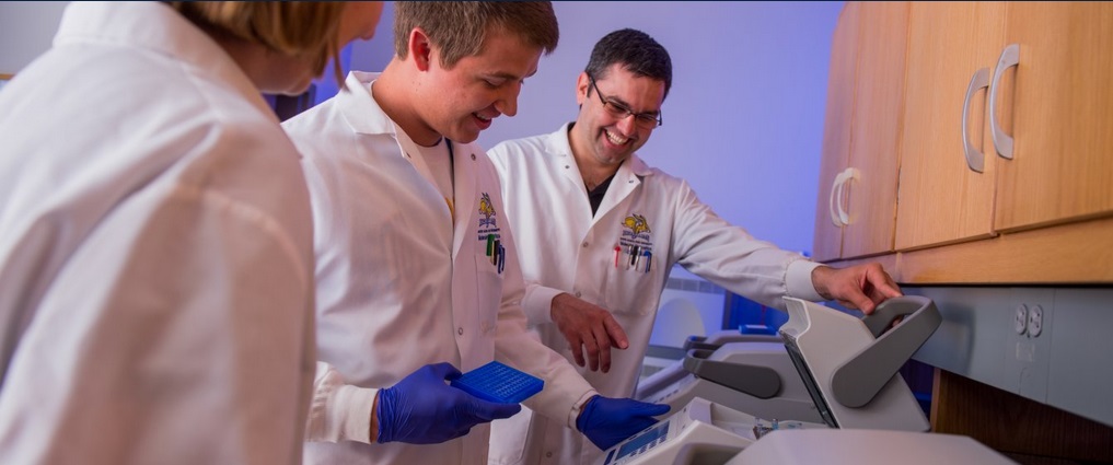 Students and instructor in a research lab.